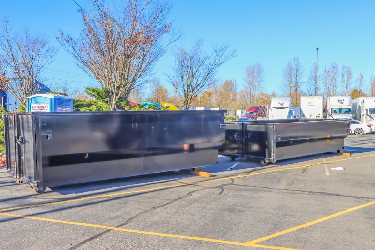 Professional dumpster rental service with roll-off container on residential driveway in Sherwood